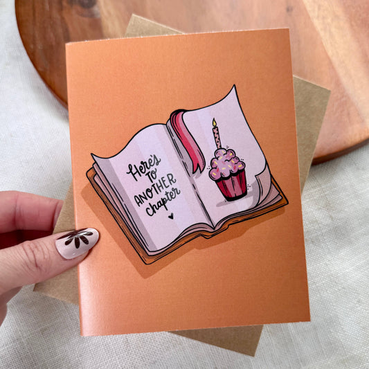 "Here's to another chapter" Bookish Birthday Card