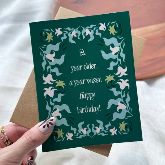 "A year older, a year wiser. Happy birthday!" Greeting Card